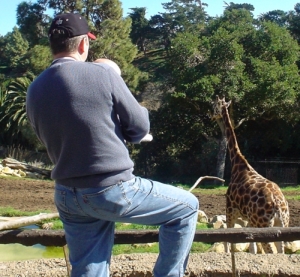 Nate and his dad watching the giraffe.